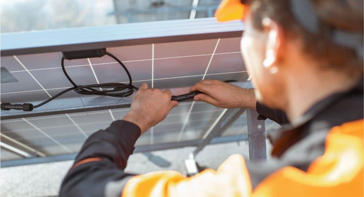 Un tecnico specializzato sta facendo la manutenzione dei pannelli fotovoltaici e di tutto l'impianto